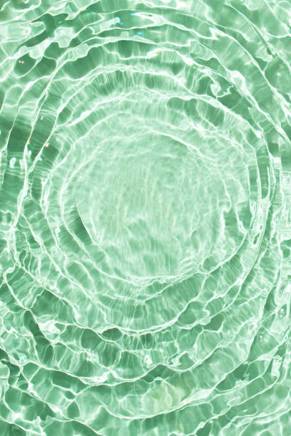 istock Flowing water with shining wave texture on a vibrant sunlight mint green background. Abstract Water surface background idea. Abstract summer template background. 2155342585