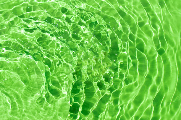 istock Rippled water with shining pattern texture on a vibrant light green background. Abstract Water surface background idea. Abstract summer background. 2155342806
