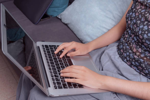 istock close-up of a woman's hands typing on her laptop 2155343191