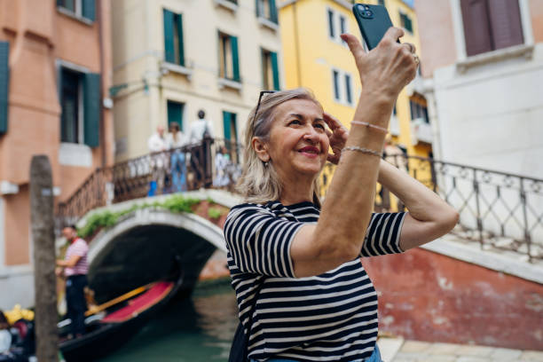 istock Female tourist posing on a canal bridge in Venice 2155346321
