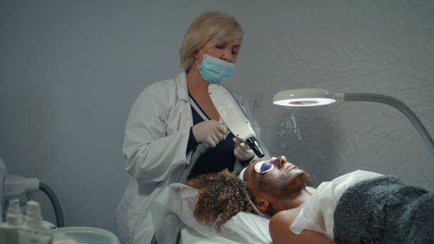 istock Professional dermatologist doing peeling treatment in modern wellness clinic 2155346679