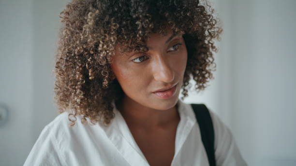 istock Smiling african american talking receptionist closeup. Curly woman writing form 2155347622