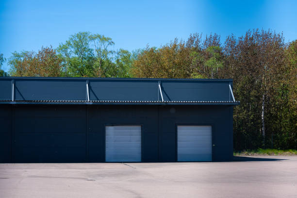 istock Grey warehouse with two garage ports.. 2155347978