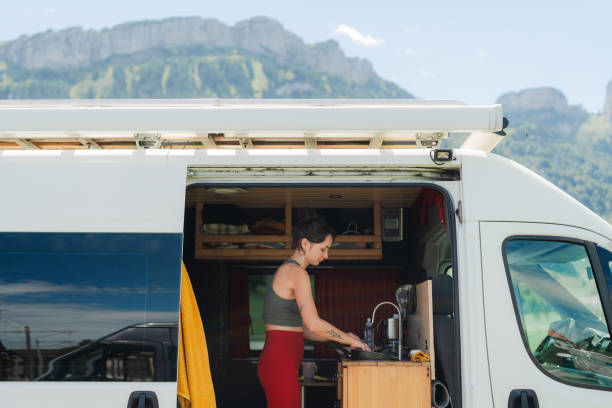 istock Woman cleaning dishes  in the  camper van 2155348721