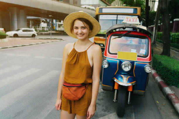 istock Woman getting off tuk-tuk exploring Bangkok 2155349004