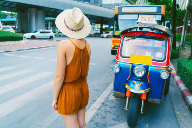 istock Woman getting off tuk-tuk exploring Bangkok 2155349110