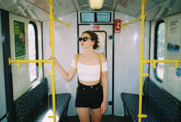 Stylish woman in sunglasses  traveling in subway train in summer. Shot with camera film
