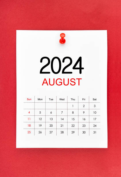 istock August 2024 calendar page with push pin on red background. 2155351822
