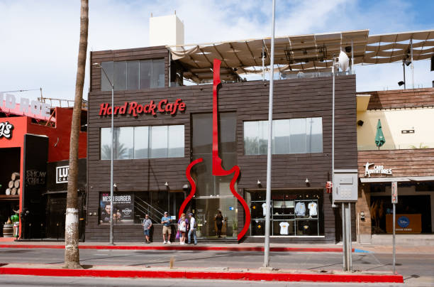 Cabo San Lucas, Mexico - March 1, 2024: People standing outside the Hard Rock Cafe on Boulevard Lazaro Cardenas.