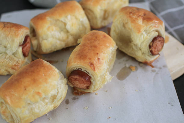 Sausage rolls on wooden table. Puff pastry eat with coffee or tea. Traditional British food concept. Food photography