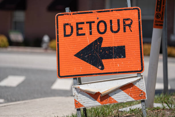 istock Orange Detour Sign Downtown For Traffic And Construction Sites 2155355054