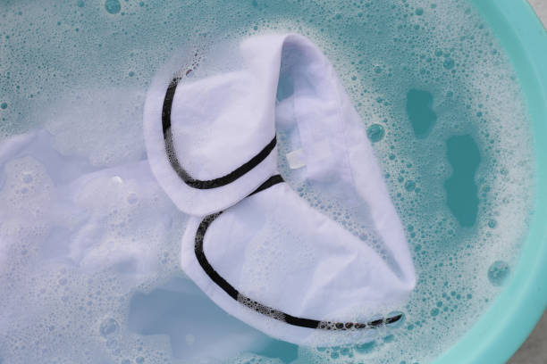 istock White cloth soaked in powder detergent water dissolution, washing cloth. Laundry concept 2155356990