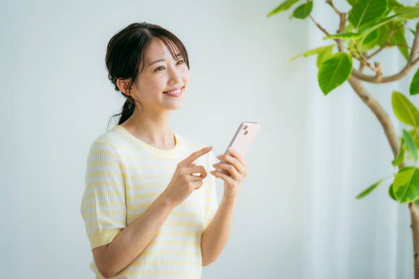 istock young woman calling on smartphone 2155360306