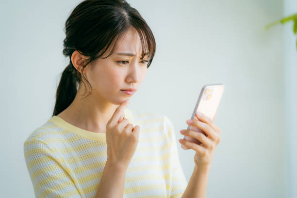 istock A woman operating a smartphone in the room 2155360336