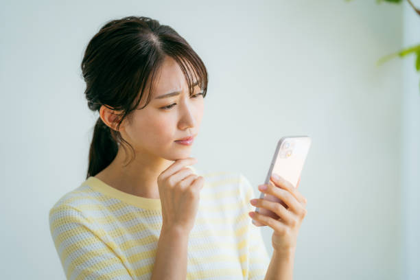 istock A woman operating a smartphone in the room 2155360337
