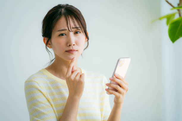 istock A woman operating a smartphone in the room 2155360342