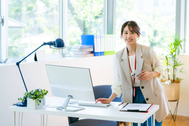 istock usiness woman with smartphone in office 2155360449