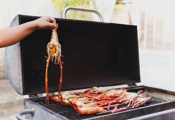 istock Grills king prawns on charcoal grill in the restaurant. 2155364085