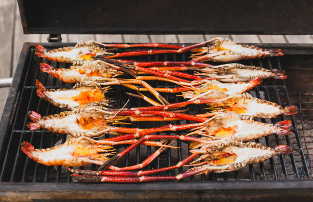 istock Grills king prawns on charcoal grill in the restaurant. 2155364102