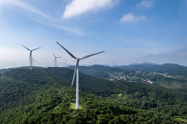 istock Forest on sunny mountains and wind turbines 2155368324