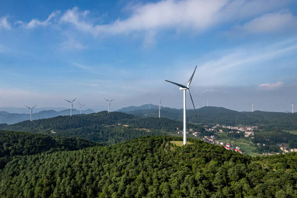 istock Forest on sunny mountains and wind turbines 2155368326