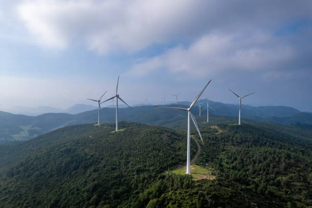 istock Forest on sunny mountains and wind turbines 2155368346