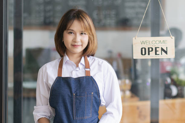 istock Asian young owner girl stand with open sign. 2155369343