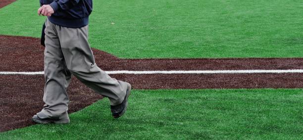 istock Baseball coach walking on new turf 2155369504