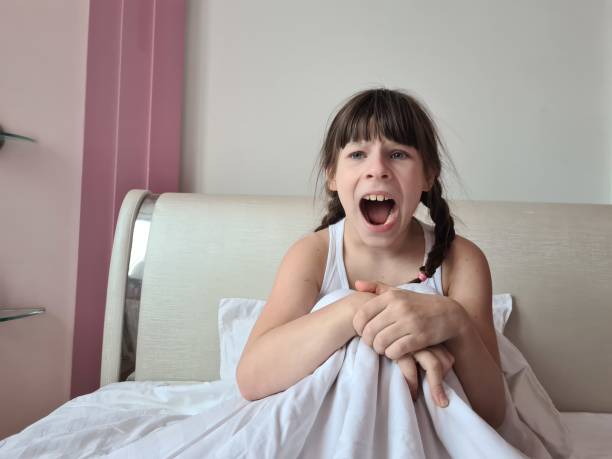istock Young Girl Yawning In Bed 2155370018