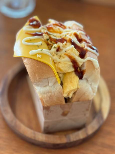 istock Scrambled Egg and Cheese Sandwich on Wooden Plate 2155370043