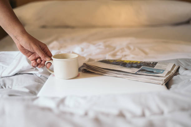 Cup of coffee, newspaper and glasses on white background close-up