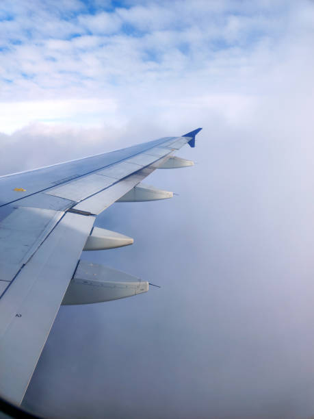 istock clouds and wing of the airplane seen from the window 2155377159
