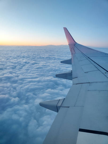 istock clouds and wing of the airplane seen from the window 2155377197