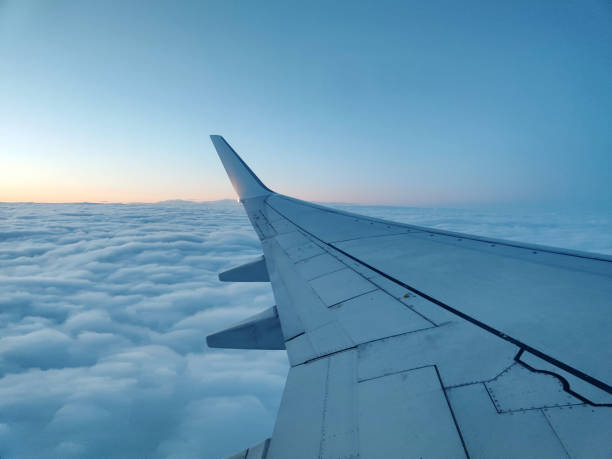 istock clouds and wing of the airplane seen from the window 2155377201