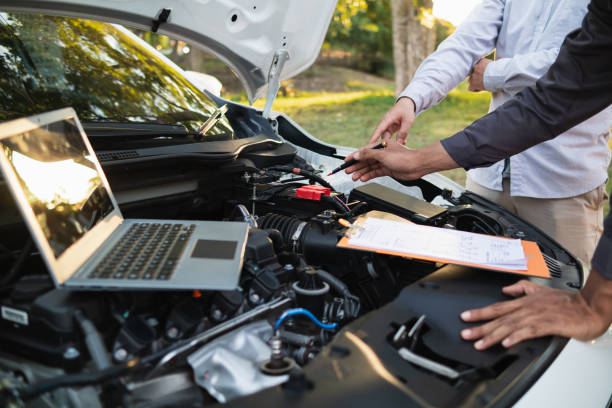 istock car service center mechanics are checking condition car and engine make sure they are ready use and in perfect condition according center warranty. periodic vehicle inspections for safety in driving. 2155380579