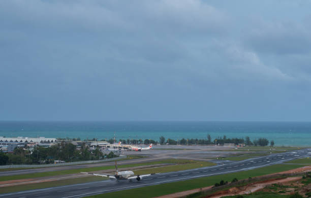 A plane is landing near beach and blue sky