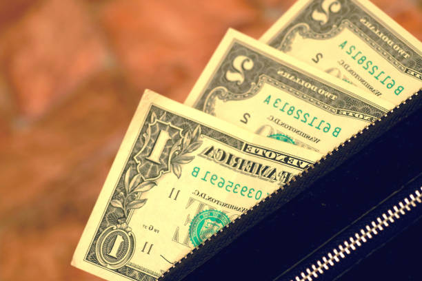 istock Banknotes in denominations of one, two dollars. Handbag, wallet, clutch 2155382657