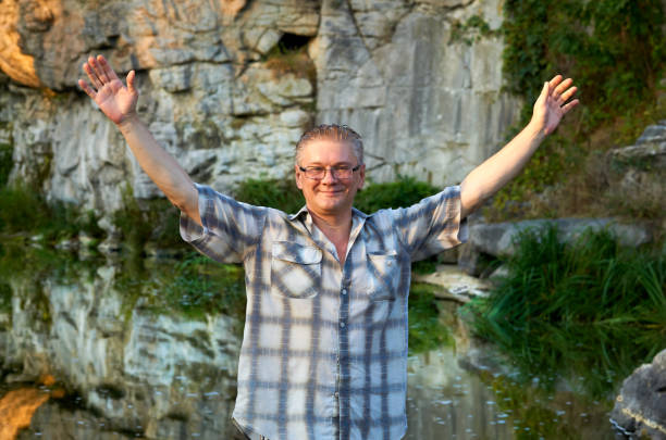 Portrait of happy businessman feeling surprised against the wall and looking at camera. Copy space.