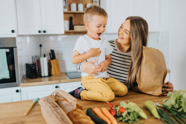 istock Mother and son organizing groceries at home 2155384243