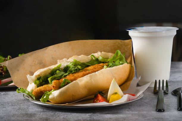 istock Fried fish sandwich with greens on the stone table. Turkish name Balik Ekmek 2155385149