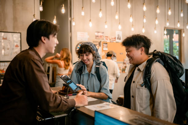 Guest Registration with Digital Tablet at Reception Desk.