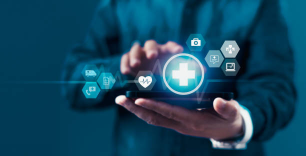 istock A man is holding a smartphone with a blue screen that has a heart and a cross on it 2155388168
