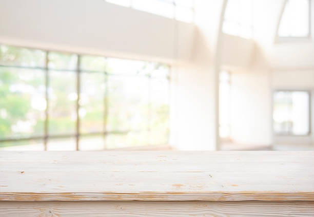 istock Empty wood table top and blur glass window wall building abstract background 2155391434