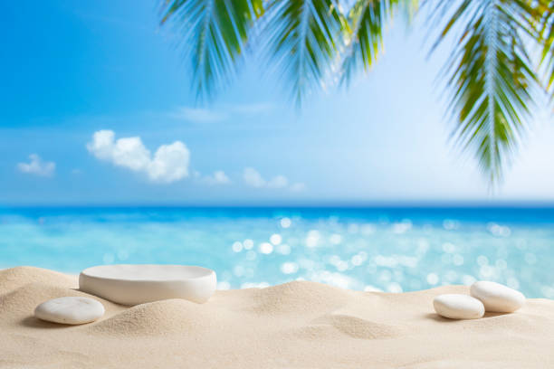 istock White stone podium with copy space for product display on tropical summer sand beach background 2155391450