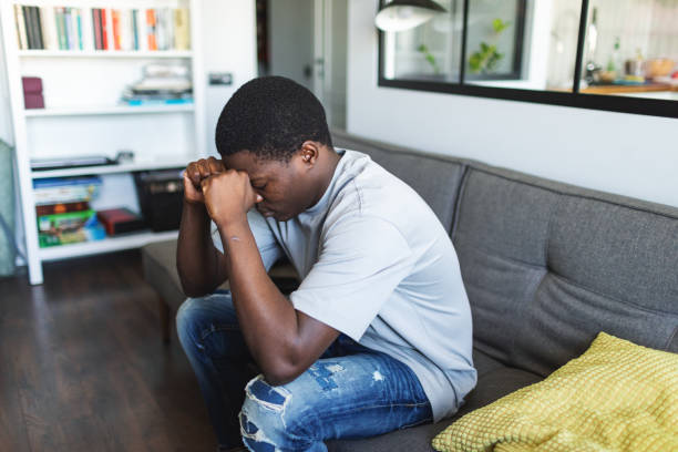istock Depressed young man sitting at home alone with rueful feelings 2155392614