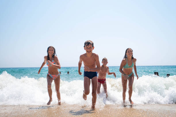 istock children run to the shore 2155393822