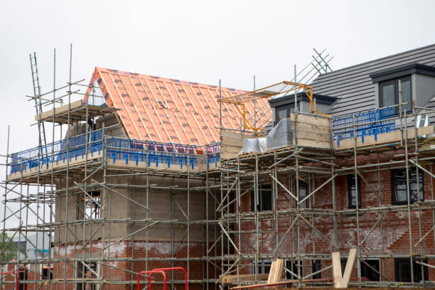 istock Scaffolding around a new house under construction 2155395153