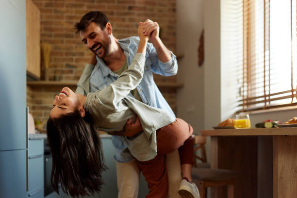 istock Happy couple in love dancing in dining room. 2155395230