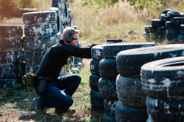 istock A man with a pistol in her hand undergoes military training at a training ground and learns to shoot. 2155397673