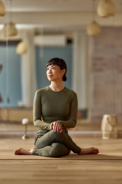 istock Japanese woman day dreaming on a break in Yoga studio. 2155398438